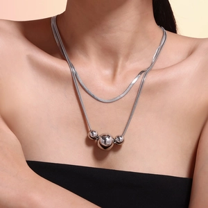 Double-layered silver necklace featuring three sphere pendants and a classic blade chain
