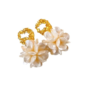 Elegant gold plated flower stud earrings with white petal clusters on a white background