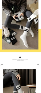 Detailed knit texture of black and white striped crew socks paired with sneakers