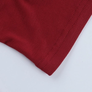 Close-up of precise stitching and burgundy rose fabric texture on off-shoulder T-shirt