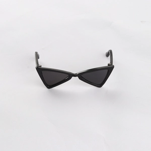 Detail view of black triangle cat eye sunglasses for small dogs and cats on white fabric
