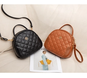 Quilted handbags in black and brown with clover buckles on elegant beige textile