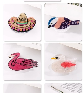 Detailed macro of vibrant acetate hair claws in flamingo, swan, and bird shapes