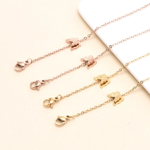 Detail of titanium steel mask chains with gold and rose gold butterfly pendants and lobster clasps