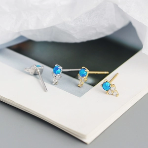Elegant S925 silver blue opal stud earrings with gold and silver accents on book