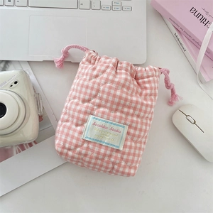 Close-up of pink checkered quilted camera bag with soft cotton heart texture detail