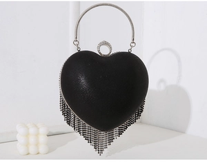 Detail of black heart evening bag with silver fringe tassels and rhinestone closure
