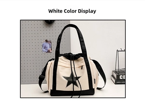 Detail of white star crossbody bag with black handles and drawstring closure
