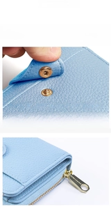 Detail of light blue lychee leather wallet featuring premium metal snap and branded zipper