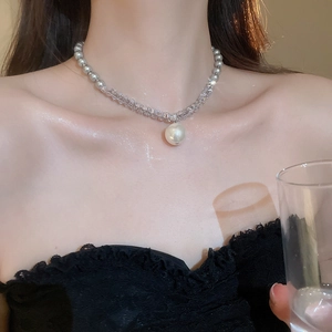 Close-up of grey pearl necklace with crystal beads and a large white pearl pendant