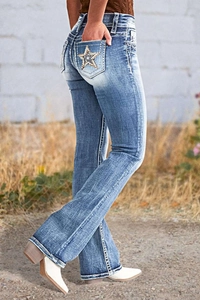 Detail of high-waisted flare jeans with star embroidery on the back pockets