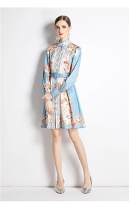 Detail of floral printed midi dress featuring a stand collar and matching waist belt