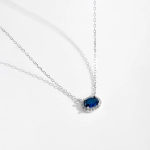 Close-up of S925 silver necklace with blue oval gemstone and pavé zircon detailing