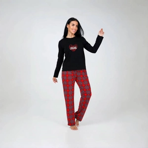 Detail of The Love Language heart print on black top with red plaid pajama pants
