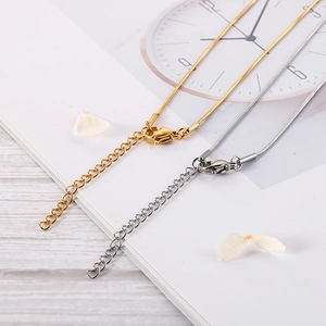 Gold and silver snake chain necklace set with lobster clasp and adjustable link details
