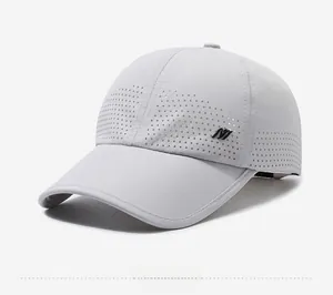 Detail of laser-perforated breathable holes and side logo on the light grey sports cap