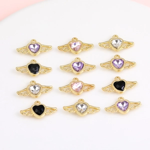 Detailed view of colorful winged heart charms for DIY jewelry making and crafting