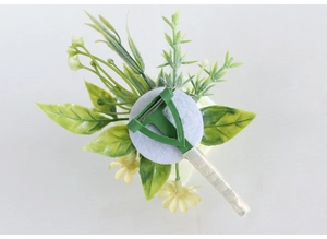 Detail of boutonniere back with plastic safety pin and white satin ribbon wrapping