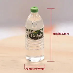 Macro detail of miniature water bottle model with green cap and brand label on wood