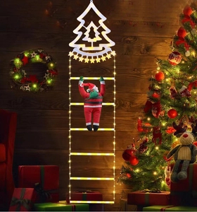Detail of warm white LED climbing ladder light with a Santa Claus figure and tree top star