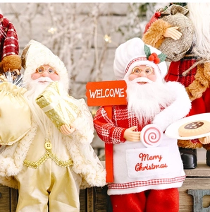 Detail of Christmas Santa figures in gold and red plaid chef outfits with Merry Christmas text