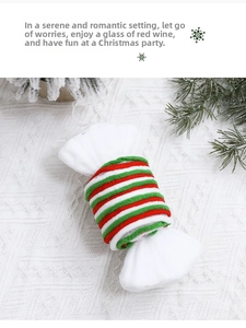 Detail of red and green elastic hair ties wrapped on a white candy plush base decoration