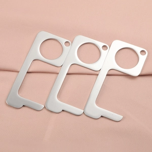 Three silver stainless steel non-contact EDC door opener tools on pink fabric background