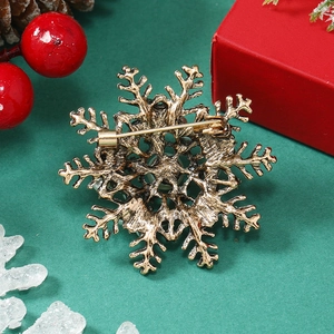 Macro detail of vintage gold snowflake brooch back with secure safety pin fastener