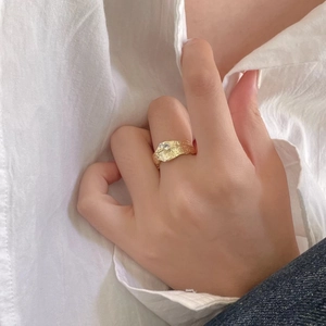 Minimalist gold textured S925 sterling silver ring with zircon stones worn by a model