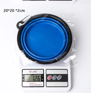 Blue portable silicone pet travel bowl on digital scale showing 126g weight and 20cm size