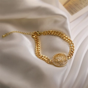 Detail of gold Cuban link bracelet featuring a hollow butterfly pendant with zircons