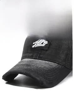Macro shot of black washed denim baseball cap with white embroidered logo and distressed brim