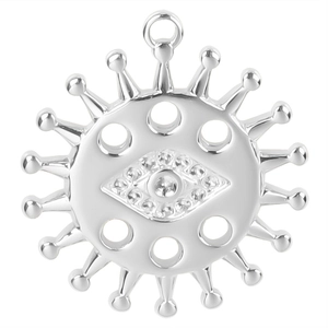 Macro detail of silver evil eye sun pendant with sparkling cubic zirconia inlay