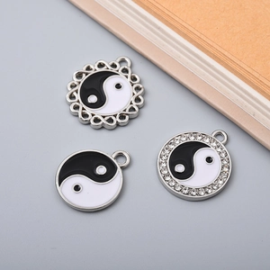 Three assorted Yin Yang charms in alloy with black and white enamel and rhinestone detail
