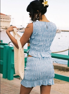 Detail of blue and white plaid two-piece set with textured fabric and button back design