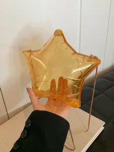 Transparent yellow star-shaped acrylic shoulder bag with gold chain strap for women