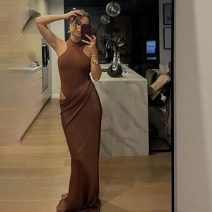 Detail of a brown silk halter bodysuit and high slit skirt set in a home mirror selfie