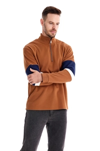 Detail of men's brown quarter-zip sweatshirt with navy and white striped cuffs