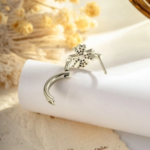 Elegant vintage silver cross earring with sparkling zircon on a white display stand