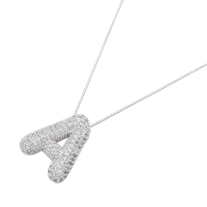 Macro shot of silver letter A pendant featuring white cubic zirconia and fine box chain