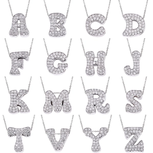 Macro display of 16 silver cursive letter pendants with micro-pave cubic zirconia crystals