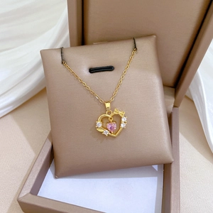 Titanium steel necklace with pink heart gem and bow pendant on brown jewelry box