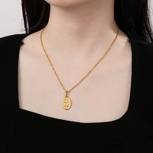 Vintage gold religious portrait pendant necklace in stainless steel on a female model