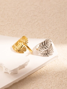 Detail of gold and silver leaf feather rings with delicate vein texture on stone