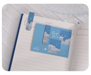 Close-up of sky pattern magnetic bookmarks set on an open diary with soft lighting