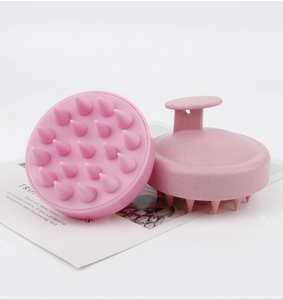 Pink silicone scalp massager brush with ergonomic grip handle and 19 flexible teeth