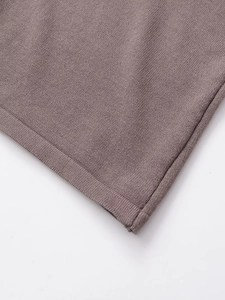 Close-up of high-quality mauve knit fabric showing the fine texture and neat stitching