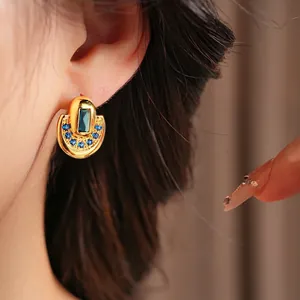 Vintage style gold half-hoop earrings featuring rectangular blue gemstone and pavé zircons