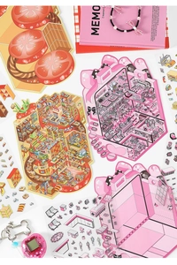 Detail view of colorful isometric scrapbooking stickers featuring home and market scenes