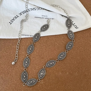 Detailed macro of vintage silver metal waist chain with oval textured links and lobster clasp